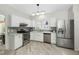 Modern kitchen with stainless steel appliances, white cabinets, and stylish backsplash at 3304 Glen Currin Dr, Raleigh, NC 27612