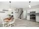 Eat-in kitchen leads to the living room, with stainless appliances, an adjacent stairway, and light-colored floors at 3304 Glen Currin Dr, Raleigh, NC 27612