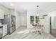 Bright eat-in kitchen features stainless appliances, tile flooring, and an adjacent dining area with natural light at 3304 Glen Currin Dr, Raleigh, NC 27612
