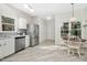 Contemporary kitchen with stainless steel appliances, white cabinets, and sleek flooring at 3304 Glen Currin Dr, Raleigh, NC 27612