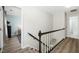 Stairway with carpeted steps and modern railing leads to bedrooms with light colored walls and wood flooring at 3304 Glen Currin Dr, Raleigh, NC 27612