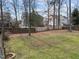 Large, grassy backyard with a wooden fence and mature trees at 3732 Coach Lantern Ave, Wake Forest, NC 27587