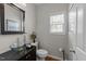 Stylish half-bathroom with a modern glass sink and elegant fixtures at 3732 Coach Lantern Ave, Wake Forest, NC 27587