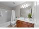 Bathroom featuring wood cabinet, sink, mirror, tub, toilet, and neutral tones at 3732 Coach Lantern Ave, Wake Forest, NC 27587
