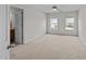 Spacious bedroom with a ceiling fan, two windows, and neutral carpet at 3732 Coach Lantern Ave, Wake Forest, NC 27587