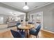Cozy dining area with a round table, blue chairs, and French doors to the outdoor deck at 3732 Coach Lantern Ave, Wake Forest, NC 27587