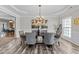 Formal dining room featuring hardwood floors, a modern chandelier, and space for entertaining at 3732 Coach Lantern Ave, Wake Forest, NC 27587