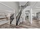 Spacious foyer with a staircase, modern floors, and views into the office and the living room at 3732 Coach Lantern Ave, Wake Forest, NC 27587