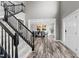 Elegant entryway boasting a grand staircase and views into the dining area with modern flooring at 3732 Coach Lantern Ave, Wake Forest, NC 27587