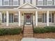 Close-up of the front porch with brick steps, decorative wreath, and white columns at 3732 Coach Lantern Ave, Wake Forest, NC 27587