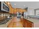 Well-equipped kitchen with wood cabinets, stainless steel appliances, and a convenient island at 3732 Coach Lantern Ave, Wake Forest, NC 27587
