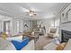 Spacious living area featuring a ceiling fan, fireplace, and multiple seating options for relaxing at 3732 Coach Lantern Ave, Wake Forest, NC 27587