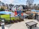 Community playground with slides and covered picnic tables for shade, surrounded by manicured landscaping at 3732 Coach Lantern Ave, Wake Forest, NC 27587