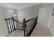Carpeted stairs with black railing and chandelier at 3732 Coach Lantern Ave, Wake Forest, NC 27587