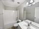 Bright bathroom with shower-tub, white fixtures, and ample mirror over the sink at 4050 Brooksdale Dr, Franklinton, NC 27525