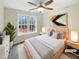 This bedroom is staged and features a ceiling fan, hardwood floors, and a large window with natural light at 4050 Brooksdale Dr, Franklinton, NC 27525