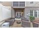 A cozy backyard patio features wicker seating, a fire pit, and access to a screened porch at 410 Bent Tree Ln, Cary, NC 27519