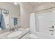 Functional bathroom with a granite topped vanity, toilet, and a shower-tub combination with basketball hoop at 410 Bent Tree Ln, Cary, NC 27519