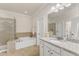Bathroom featuring a vanity with a granite countertop, soaking tub, and walk-in shower at 410 Bent Tree Ln, Cary, NC 27519