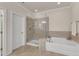 Bathroom featuring a soaking tub, walk-in shower, and tiled floors at 410 Bent Tree Ln, Cary, NC 27519