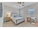 Cozy bedroom with neutral decor, featuring a comfortable bed, desk and a window at 410 Bent Tree Ln, Cary, NC 27519