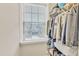 Organized closet with clothing racks, shelving, and a window for natural light at 410 Bent Tree Ln, Cary, NC 27519