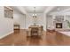 Open-concept dining area with rustic wood table, chairs, bench, and fireplace with stone surround in the background at 410 Bent Tree Ln, Cary, NC 27519