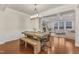 Beautiful dining area with wood table, bench, and chairs, with a living room with a fireplace in the background at 410 Bent Tree Ln, Cary, NC 27519