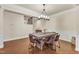 Elegant dining area showcasing a rustic wood table and chairs under a modern chandelier, next to staircase at 410 Bent Tree Ln, Cary, NC 27519