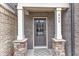 Inviting front door with stylish columns and stone accents, leading into a charming home at 410 Bent Tree Ln, Cary, NC 27519