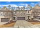 Townhome exterior with a two-car garage, brick accents, and a cozy front yard at 410 Bent Tree Ln, Cary, NC 27519