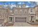 Charming townhome with stone and brick facade, two-car garage, and well-maintained landscaping at 410 Bent Tree Ln, Cary, NC 27519