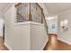 A staircase with wood and metal railings flows into the entry of this well-lit and inviting home at 410 Bent Tree Ln, Cary, NC 27519