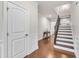 Open foyer featuring hardwood floors, a staircase, and a decorative table with vases at 410 Bent Tree Ln, Cary, NC 27519