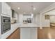 Modern kitchen with stainless steel appliances, granite counters, large island with seating and hanging pendant lights at 410 Bent Tree Ln, Cary, NC 27519