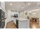 Spacious modern kitchen with stainless steel appliances, granite countertops, and central island with dishwasher at 410 Bent Tree Ln, Cary, NC 27519