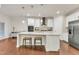 Open kitchen with island, stainless steel appliances, and modern pendant lighting at 410 Bent Tree Ln, Cary, NC 27519