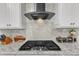Modern kitchen features granite countertops, stainless steel range hood, and tile backsplash at 410 Bent Tree Ln, Cary, NC 27519