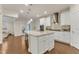 Bright kitchen with white cabinets, granite countertops, large island with seating and stainless steel appliances at 410 Bent Tree Ln, Cary, NC 27519