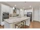 Bright, modern kitchen features stainless steel appliances, large island with seating, and pendant lighting at 410 Bent Tree Ln, Cary, NC 27519