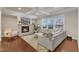 Cozy living room with stone fireplace, coffered ceilings, and hardwood floors at 410 Bent Tree Ln, Cary, NC 27519