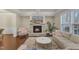 Cozy living room with stone fireplace, coffered ceilings, and hardwood floors at 410 Bent Tree Ln, Cary, NC 27519