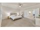 Spacious main bedroom with neutral tones, a ceiling fan, and access to other rooms at 410 Bent Tree Ln, Cary, NC 27519