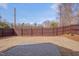 Large, fenced backyard featuring a well-maintained lawn, privacy fence and a brick patio at 411 Dunstan Ave, Durham, NC 27707