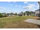 A large backyard with a concrete patio overlooking the community at 44 Fairwinds Drive Dr, Lillington, NC 27546