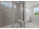 Modern bathroom featuring tile shower with glass door and built-in bench and tile floors at 44 Fairwinds Drive Dr, Lillington, NC 27546