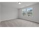 Neutral bedroom with two windows overlooking the neighborhood at 44 Fairwinds Drive Dr, Lillington, NC 27546