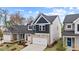 A two-story home with a stone facade, showcasing its side yard and clean lines at 44 Fairwinds Drive Dr, Lillington, NC 27546