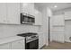 Close-up of a modern stove and oven with a subway tile backsplash and countertops at 44 Fairwinds Drive Dr, Lillington, NC 27546