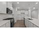 Bright white kitchen featuring modern appliances, subway tile backsplash, and spacious countertops at 44 Fairwinds Drive Dr, Lillington, NC 27546